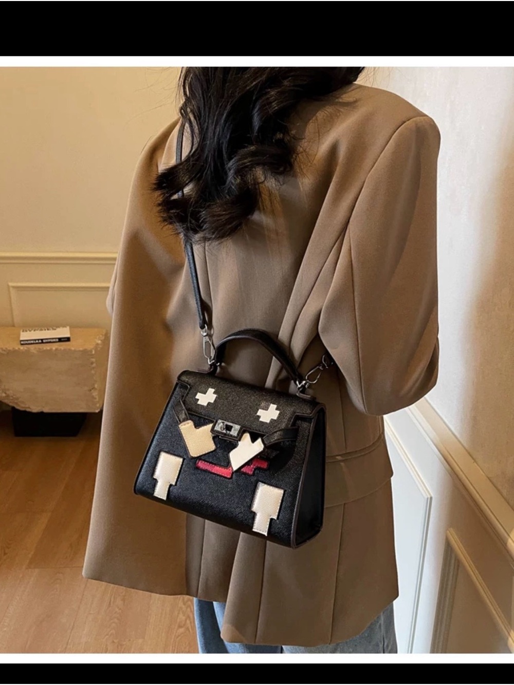 Stylish Black Top-Handle Crossbody Bag with Graphic Accents